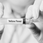 Yellow Fever injection is held between the fingers of two hands. The words Yellow Fever are written across the injection.